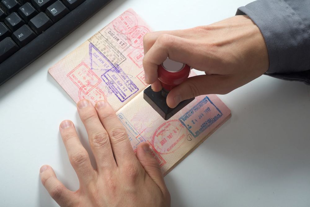 Passport being stamped with visa documents